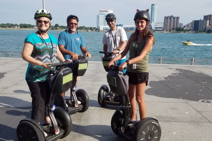 a group of people riding on the back of a motorcycle